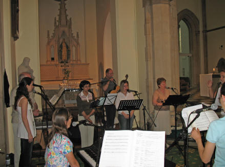 The group singing the last song of rehearsal before Mass proper.