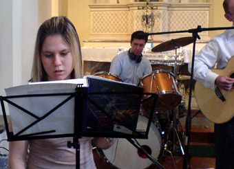 Image of our youngest member rehearsing before Mass. Drummer in background.